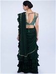 green ready pleated saree with frilled layers at the hem